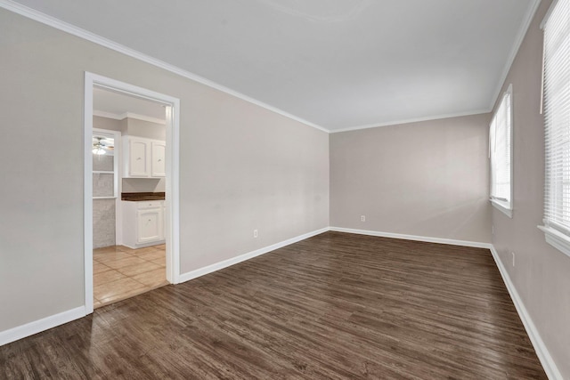 spare room with ceiling fan, dark hardwood / wood-style flooring, and crown molding