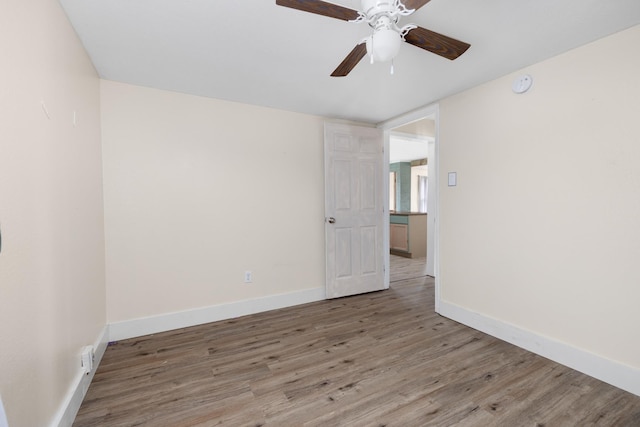 empty room with ceiling fan and light wood-type flooring