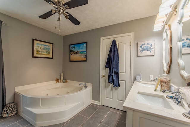 bathroom featuring a washtub, a textured ceiling, vanity, ceiling fan, and tile patterned flooring