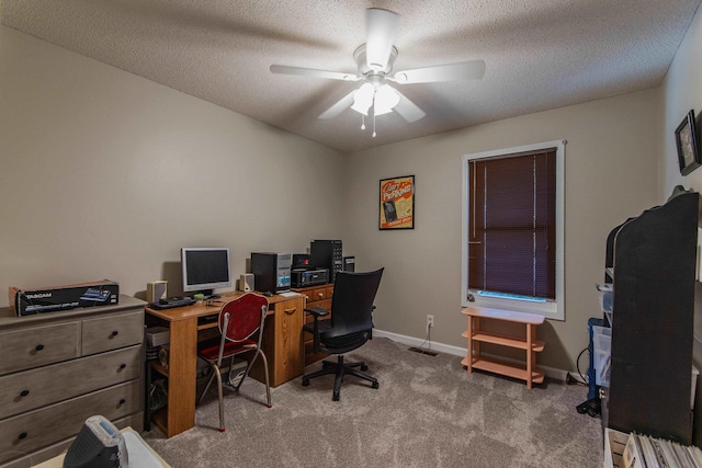 office space with carpet, a textured ceiling, and ceiling fan