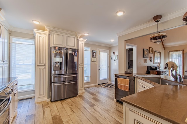 kitchen with sink, stainless steel appliances, cream cabinets, light wood-type flooring, and ornamental molding