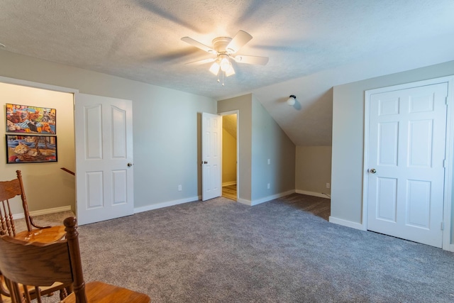 additional living space with carpet flooring, lofted ceiling, ceiling fan, and a textured ceiling