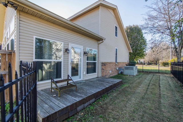 back of property featuring a deck and a yard