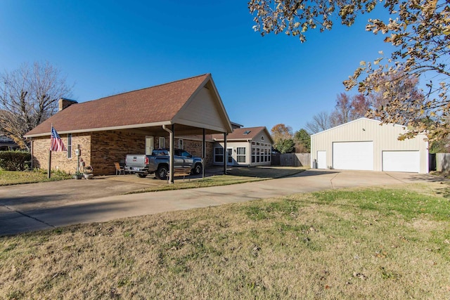 view of home's exterior with an outbuilding, a yard, a garage, and a carport