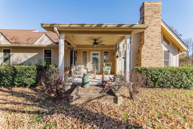 back of house featuring covered porch and ceiling fan