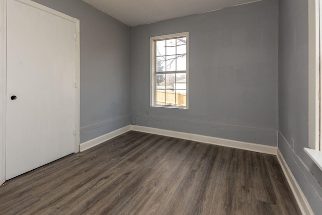 spare room with dark hardwood / wood-style floors