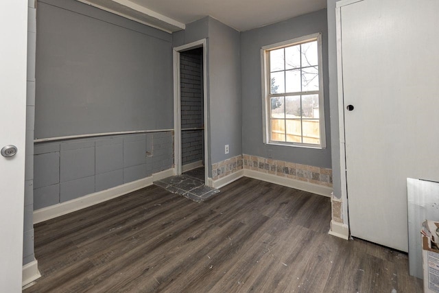 empty room with dark wood-type flooring