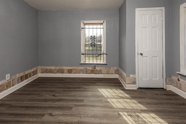 unfurnished room featuring dark hardwood / wood-style flooring