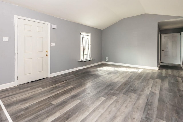 foyer with vaulted ceiling and dark hardwood / wood-style floors