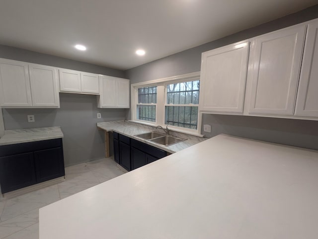 kitchen featuring sink and white cabinets