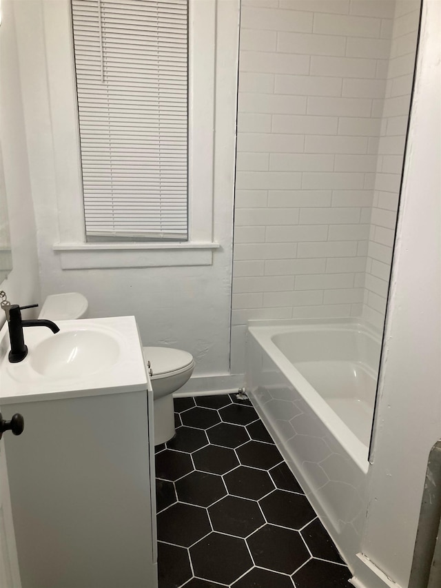 bathroom featuring tile patterned floors, vanity, and toilet