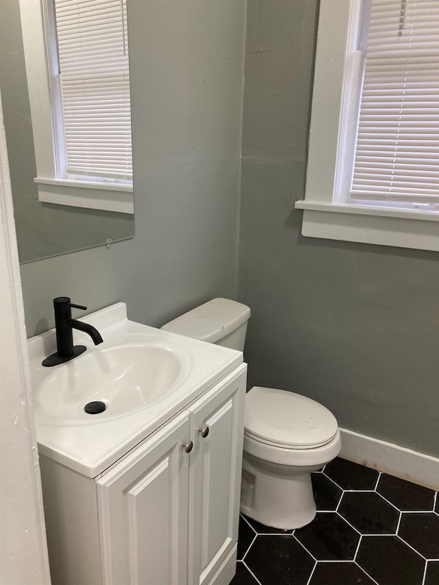 bathroom featuring tile patterned floors, vanity, and toilet