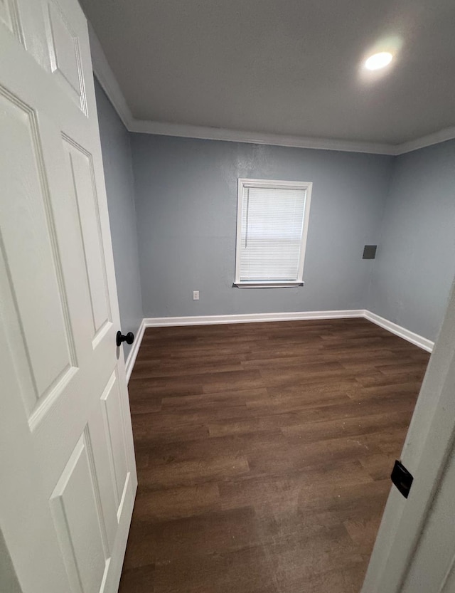 unfurnished room with dark hardwood / wood-style floors and crown molding