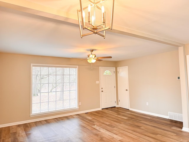 entryway featuring wood-type flooring and ceiling fan with notable chandelier