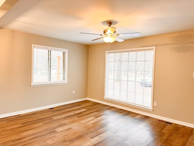 spare room featuring ceiling fan and light hardwood / wood-style flooring