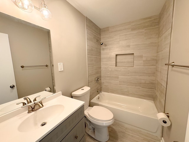 full bathroom with vanity, toilet, and tiled shower / bath