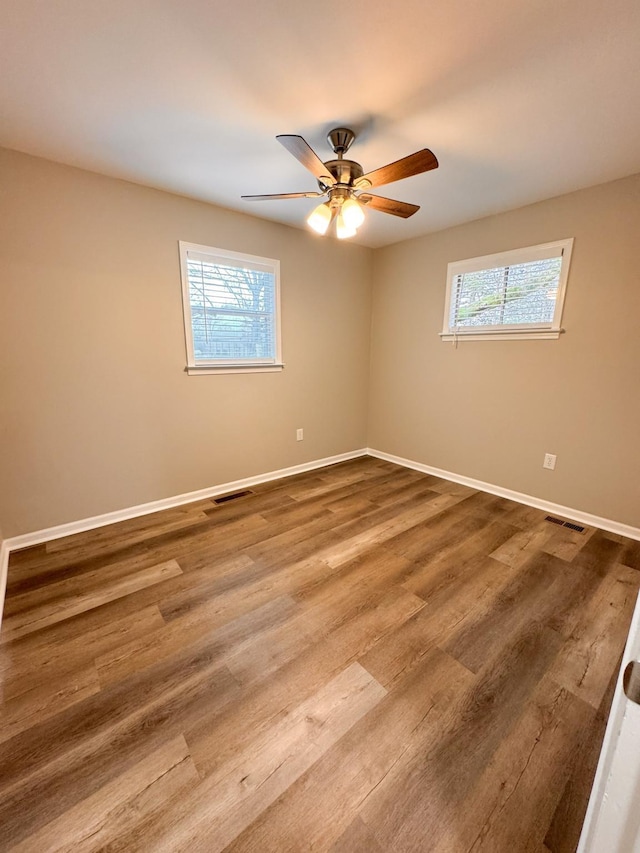 empty room featuring hardwood / wood-style floors and ceiling fan