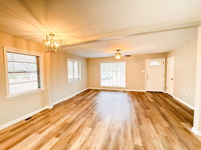 interior space with ceiling fan with notable chandelier and light hardwood / wood-style floors