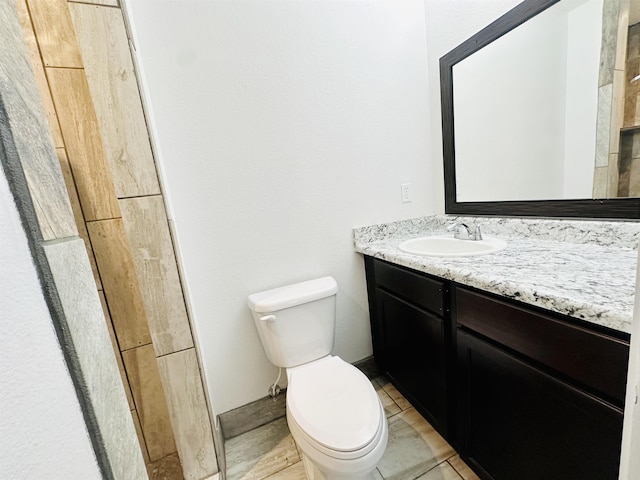 bathroom featuring tile patterned flooring, vanity, and toilet