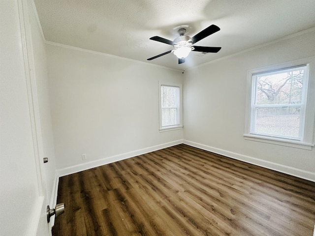 unfurnished room featuring plenty of natural light, ornamental molding, and dark wood-type flooring