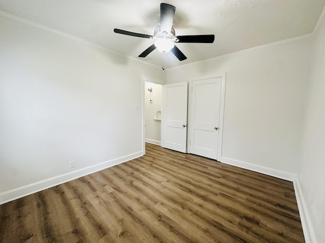 unfurnished bedroom with wood-type flooring, ceiling fan, and ornamental molding