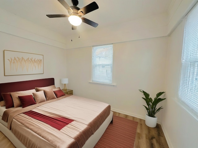 bedroom featuring wood-type flooring and ceiling fan