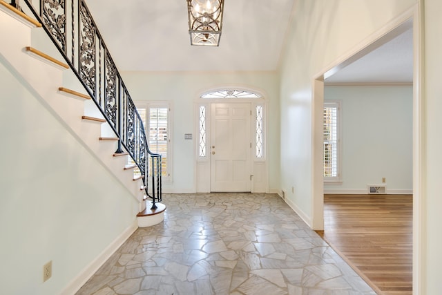 foyer featuring light hardwood / wood-style floors and ornamental molding