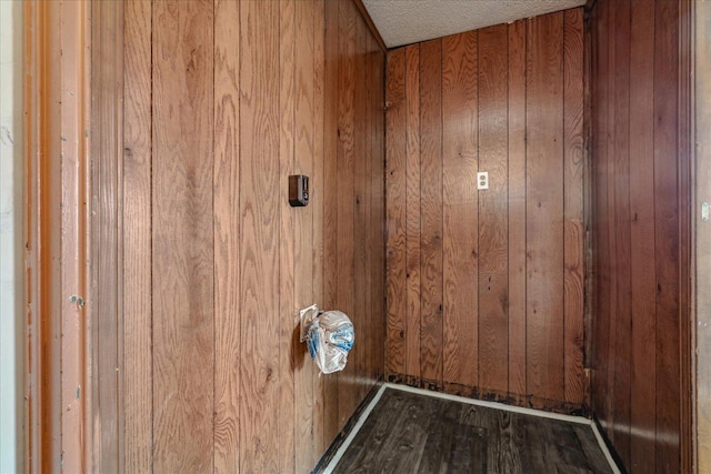 washroom featuring wooden walls and hardwood / wood-style floors