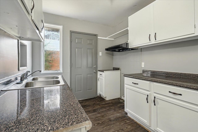 kitchen featuring white cabinets, dark stone countertops, sink, and dark wood-type flooring