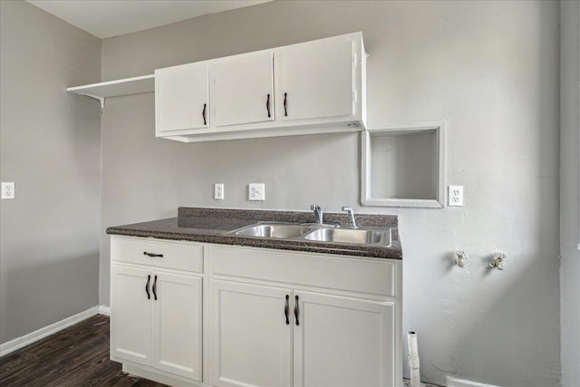 kitchen with white cabinets, sink, and dark wood-type flooring