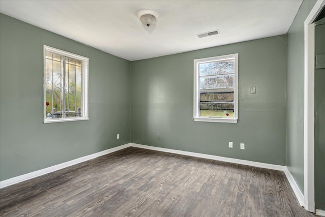 unfurnished room with dark hardwood / wood-style floors