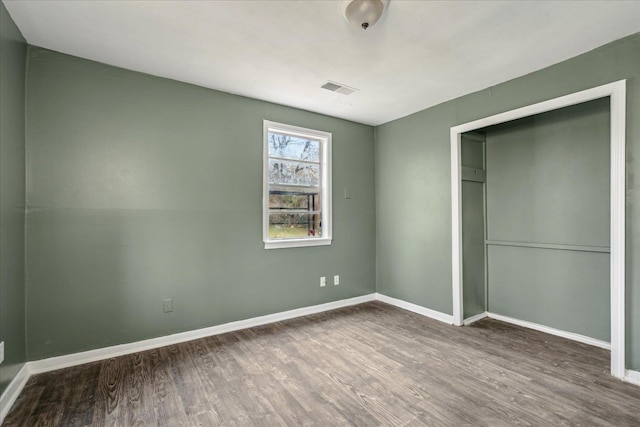 unfurnished bedroom featuring a closet and wood-type flooring