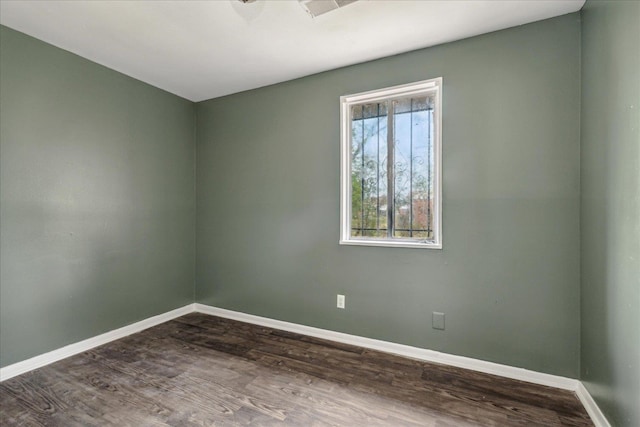 spare room featuring dark hardwood / wood-style floors