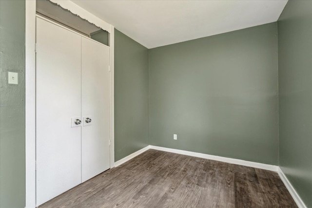 unfurnished bedroom featuring a closet and hardwood / wood-style floors