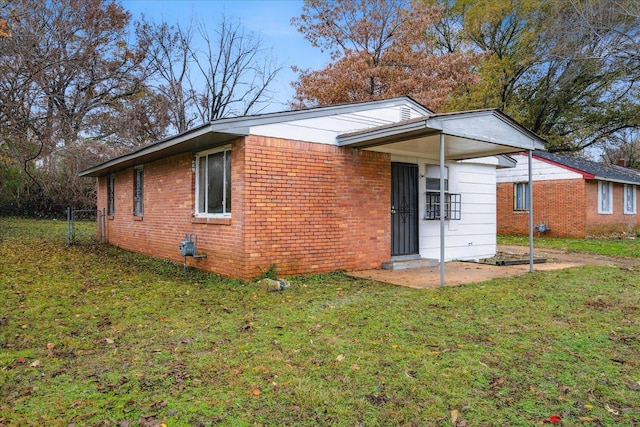 rear view of property featuring a lawn