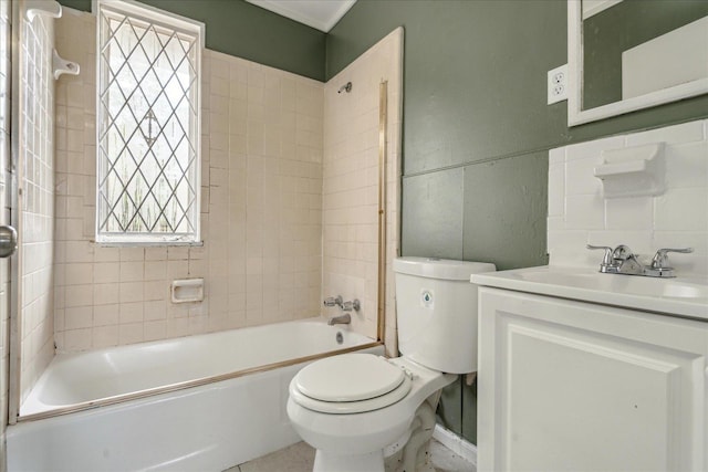 full bathroom featuring vanity, toilet, tiled shower / bath, and a healthy amount of sunlight