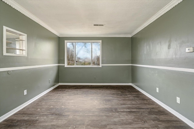 empty room with dark hardwood / wood-style flooring and crown molding