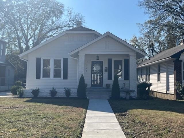 bungalow with a front lawn