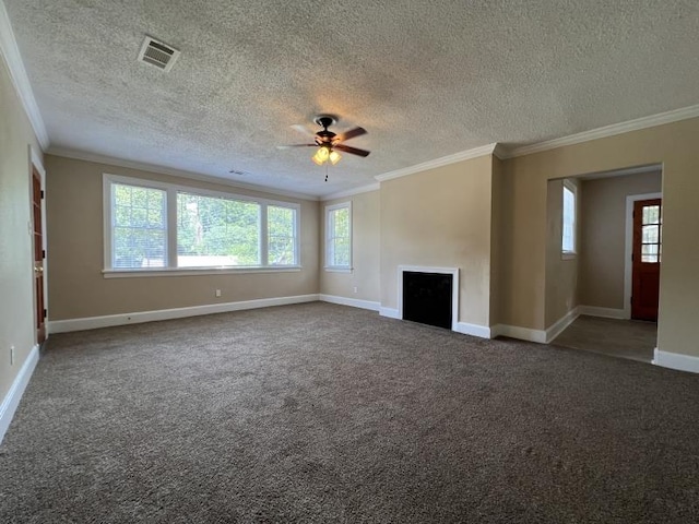 unfurnished living room featuring dark carpet, ornamental molding, and a textured ceiling