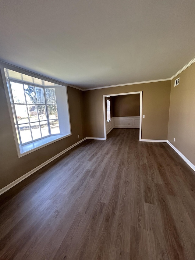 unfurnished living room with baseboards, visible vents, ornamental molding, and dark wood-style flooring