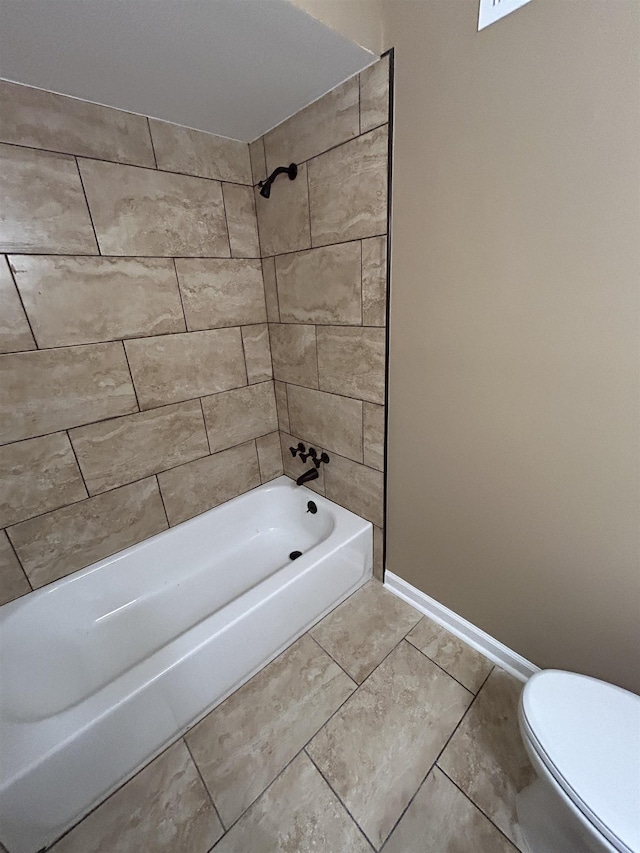 bathroom featuring toilet, bathtub / shower combination, and baseboards