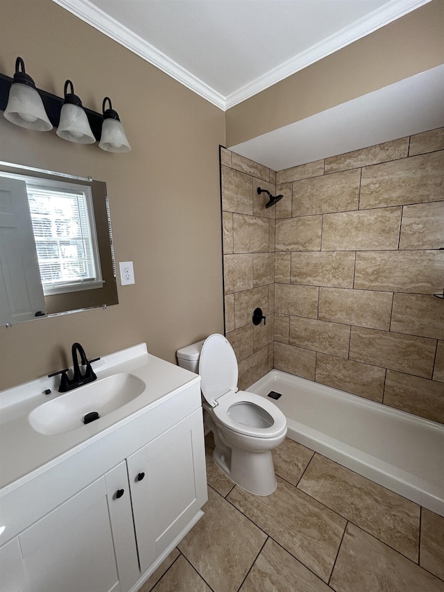 bathroom featuring toilet, a tile shower, crown molding, and vanity