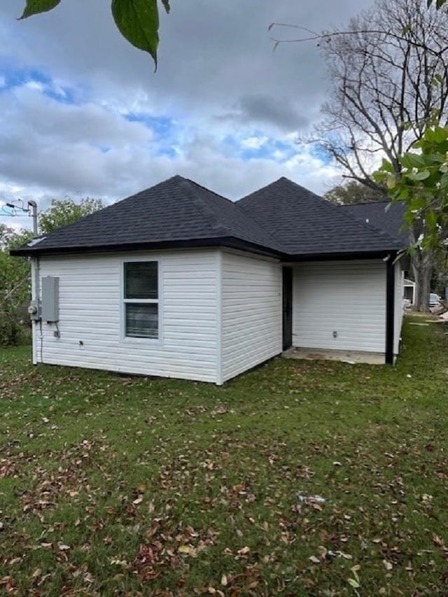 view of side of property with a yard