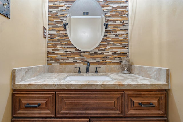 bathroom featuring vanity and backsplash