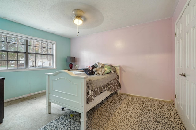 bedroom featuring a textured ceiling, a closet, and ceiling fan