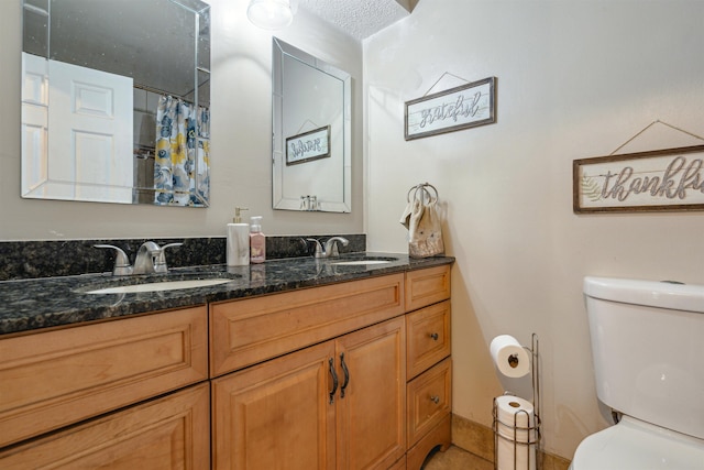 bathroom featuring toilet, a textured ceiling, vanity, curtained shower, and tile patterned flooring