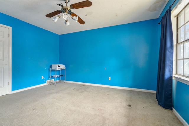 carpeted empty room with ceiling fan