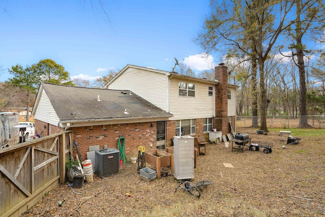 back of house featuring central AC unit