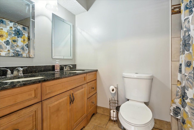 bathroom with tile patterned flooring, vanity, curtained shower, and toilet