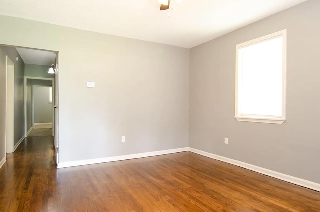 unfurnished room featuring dark wood-type flooring